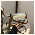 Detail of multi-color woven shoulder bag with brown leather trim and metal lobster clasp - Brown