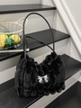 Black faux fur bucket bag with vertical stripe design and silver metal bow accent - Black