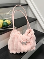 Pink faux fur shoulder bag with silver bow accent and vertical striped texture - Pink