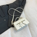 Minimalist white square crossbody bag with dual zippers and gold hardware on blazer - White