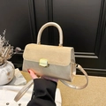 Golden beige winter handbag with metallic finish and suede拼接 showing handheld usage - Khaki