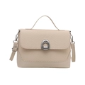 Minimalist beige shoulder bag with woven flap and silver horseshoe buckle on white background - White