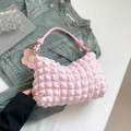 Pink bubble texture cylinder bag with matching floral charm and knotted handle strap - Pink