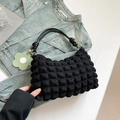 Black bubble texture cylinder bag with rope handle and green flower charm accessory - Black