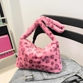 Chic pink leopard print faux fur tote bag hanging on a chair in a stylish room setting - Pink