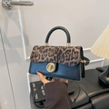 Leopard print crossbody bag with golden clasp and black faux leather finish - Black