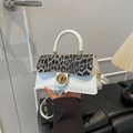 Mini leopard print crossbody bag with white leather and gold circular lock detail - White