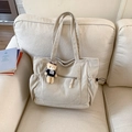 Beige corduroy tote bag with front zipper pocket and plush bear charm on a cozy sofa - Beige (With Charm)