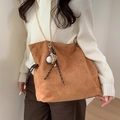 Brown suede bucket bag detail with golden chain strap and baseball glove pendant decoration - Brown With Braided Rope Baseball Charm