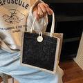 Borsa in lino con ricamo floreale nero e manici in corda di cotone bianco - Nero