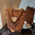 Brown corduroy handbag featuring black heart and bow prints with a woven brand label - Brown