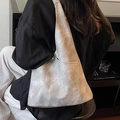 Minimalist light grey tote bag in washed leather finish with side pocket on model - Gray
