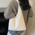 Minimalist white canvas tote bag with shoulder straps and front pocket for daily commute - Off White