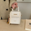 White structured handbag with gold stud trim and a bohemian beaded charm - With Beaded Pendant / White
