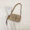 Khaki frosted suede crossbody bag with gold horseshoe buckle and baseball charm detail - Khaki With Baseball Charm