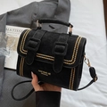Elegant black matte satchel with golden studs and dual strap design in a stylish setup - Black