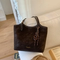 Dark brown large tote bag with contrast stitching and golden hardware on sofa - Coffee (With Pendant)