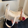Cream-white crescent shoulder bag in soft faux leather with a cute plush charm - Beige (With Charm) / Off White