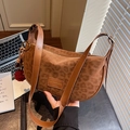 Brown leopard print suede dumpling bag with leather strap and red pompom charm detail - Brown Leopard Print (With Charm) / Brown