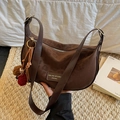 Dark brown crescent crossbody bag in faux suede with a plush ball charm detail - Coffee Leopard Print (With Charm) / Coffee