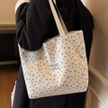 Off-white corduroy tote bag featuring brown heart and pink bow prints worn by model - Zipper Style / White / Large
