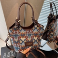 Quilted multi-color bucket bag with brown leather handle and gold hardware detail - Blue Plaid