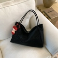 Large black suede tote bag with apple plush pendant on a minimalist cream sofa - With Pendant / Black