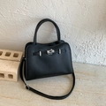 Detail of black lychee grain leather handbag with silver metal turn-lock and strap - Black - Without Pendant
