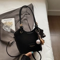 Minimalist black bucket handbag with baseball charm and gold logo on casual clothing - Black With Baseball Pendant