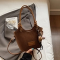 Deep brown bucket bag in matte leather with a creative baseball charm accessory - Brown With Baseball Charm