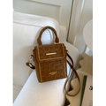 Brown leopard print suede crossbody square bag with gold studs on a white sofa - Brown No Pendant