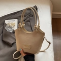 Beige leather bucket bag with unique knot handle and gold hardware in elegant setting - Rice White (No Pendant)