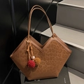 Leopard print tote bag with V-shaped opening and plush pompom charms on grey stairs - Brown With Colorblock Pompom Charm