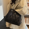 Black quilted tote bag with chain strap and brand lettering on vintage texture fabric - Black Without Charm