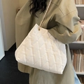 White quilted large tote bag with gold chain strap shown on person in lifestyle setting - Rice White (Without Pendant)
