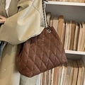 Deep coffee quilted tote bag with vintage leather texture and chain strap worn by model - Coffee Without Charm