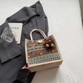 Ethnic woven jute handbag in beige with colorful geometric patterns and pompom charm - Brown Button Style With Brown Elf Charm