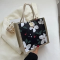 Sac à lunch en toile florale avec poignées en jute beige et bouton en bois naturel - Noir