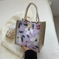 Floral print tote bag with purple fabric, jute sides, and a natural wooden button closure - Purple
