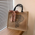 Natuurlijke linnen shopper met zwarte olifantenprint en bloemenlint op houten decor - Olifant Print Met Sjaal