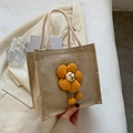 Linen lunch bag in natural jute finish with an orange plush flower pendant - Orange