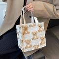 Chic cream canvas tote bag with brown bear pattern and comfortable woven handles - White Small