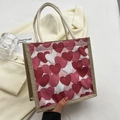 Linen heart print tote bag with woven rope handles shown in hand for daily use - Zipper Style / Red