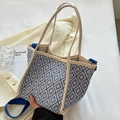 Blue and white geometric woven bucket bag with beige handles and blue fabric strap - Blue