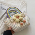 White woven handbag with rainbow handles and a large yellow fabric flower detail - White