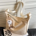 Creamy white lychee leather crossbody bag with wide strap and plush pendant - Off-White with Pendant