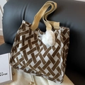 Brown and white geometric woven tote bag with plush charm on a black leather sofa - Large Coffee With White Heart Pendant