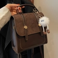 Vintage dark brown leather backpack with gold buckles and a cute plush keychain - Coffee With Plush Monster Pendant