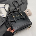 Retro black leather backpack with white stitching and bear charm on grey blazer - Black With Pink Chain Cloud Charm