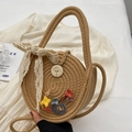 Khaki round straw crossbody bag with white lace bow and floral appliques held by hand - Khaki And Blue (With Silk Scarf)